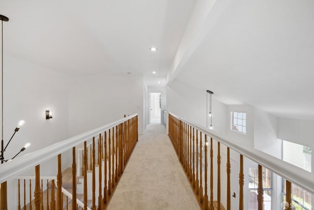 hallway with recessed lighting and light colored carpet