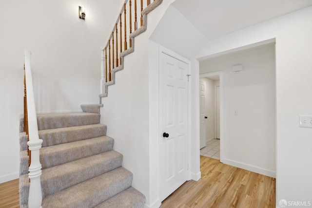 stairs with baseboards and wood finished floors
