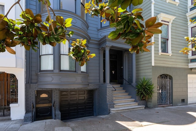 350 Dolores St, San Francisco, CA 94110 - view of exterior entry with concrete driveway and an attached garage