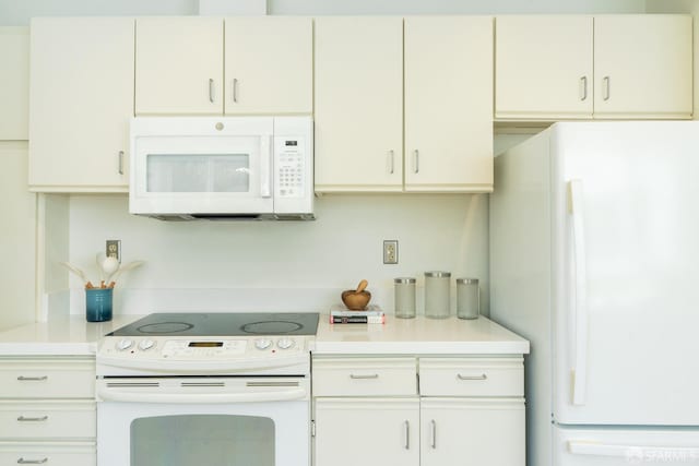 350 Dolores St, San Francisco, CA 94110 - kitchen featuring white appliances, white cabinetry, and light countertops
