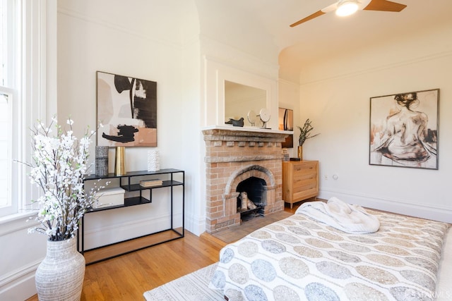 350 Dolores St, San Francisco, CA 94110 - bedroom with a brick fireplace, wood finished floors, and ceiling fan