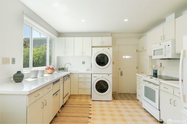 350 Dolores St, San Francisco, CA 94110 - kitchen with stacked washer / drying machine, a sink, white appliances, light countertops, and light floors
