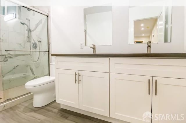 31-33 Harriet St, San Francisco, CA 94103 - bathroom with double vanity, a marble finish shower, and wood finished floors