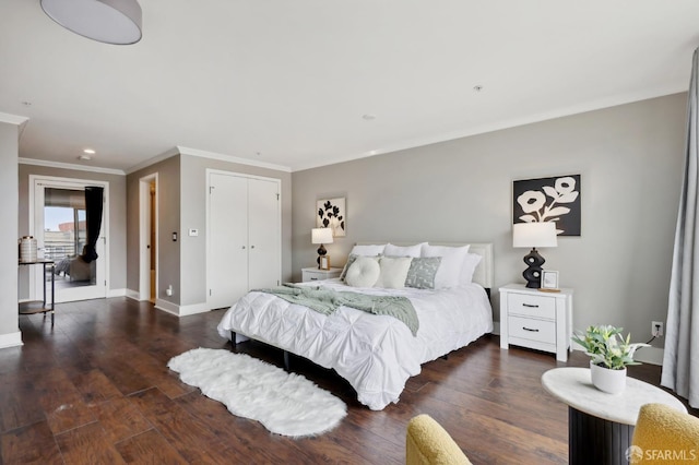 bedroom featuring ornamental molding, dark hardwood / wood-style flooring, and a closet