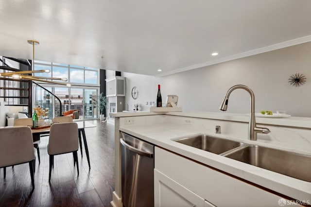 kitchen with sink, crown molding, dishwasher, expansive windows, and dark hardwood / wood-style flooring