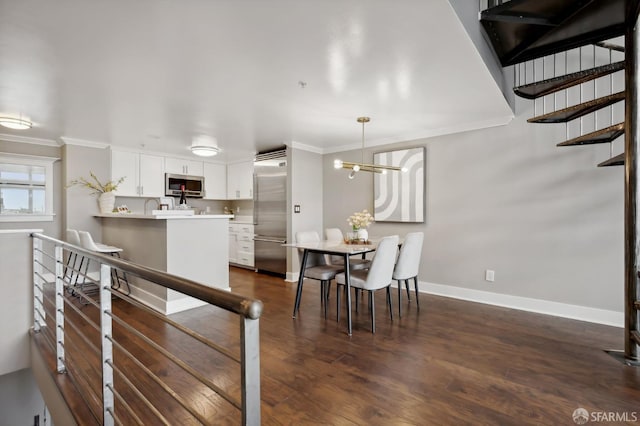 interior space featuring an inviting chandelier, ornamental molding, and dark hardwood / wood-style floors