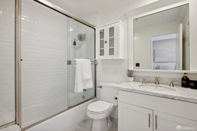 full bathroom with toilet, vanity, and shower / bath combination with glass door