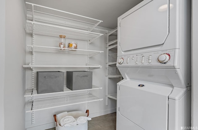 clothes washing area with stacked washer and dryer