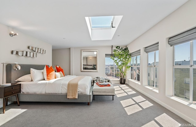 bedroom with a skylight and carpet floors