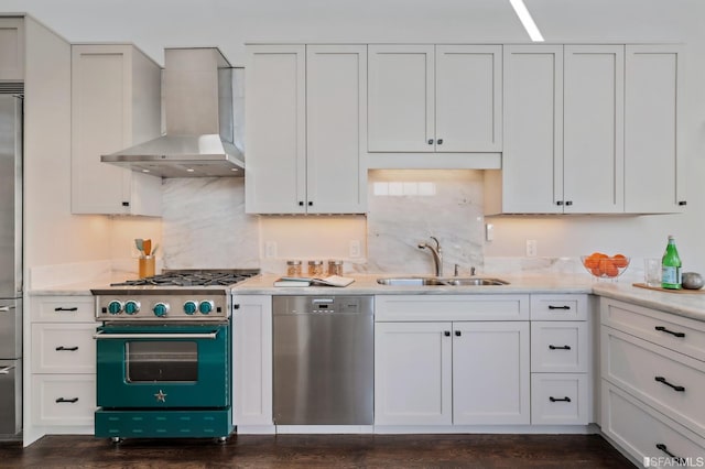 kitchen with white cabinets, wall chimney exhaust hood, sink, and stainless steel appliances