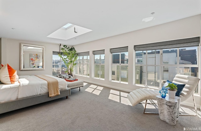 bedroom featuring carpet flooring and a skylight