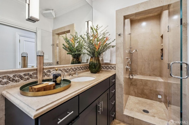 full bath featuring vanity, tile walls, ornamental molding, a shower stall, and tasteful backsplash