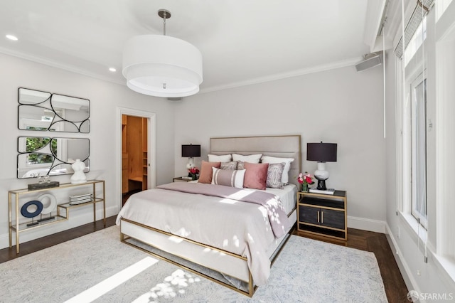 bedroom with recessed lighting, baseboards, crown molding, and wood finished floors