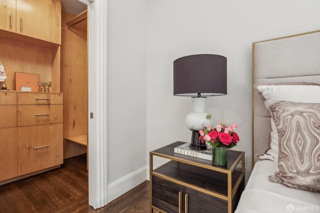 bedroom with dark wood-style floors and baseboards