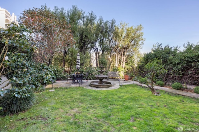 view of yard featuring fence and a patio