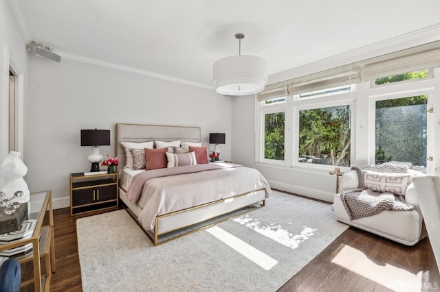 bedroom featuring crown molding, baseboards, and dark wood-style flooring