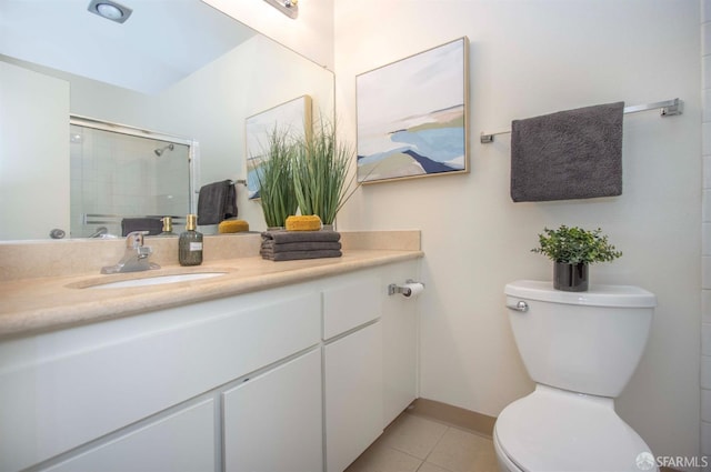 bathroom featuring toilet, tile patterned flooring, a shower with door, and vanity