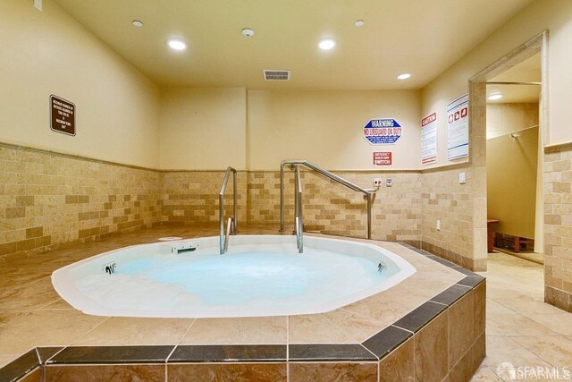 view of swimming pool featuring an indoor in ground hot tub