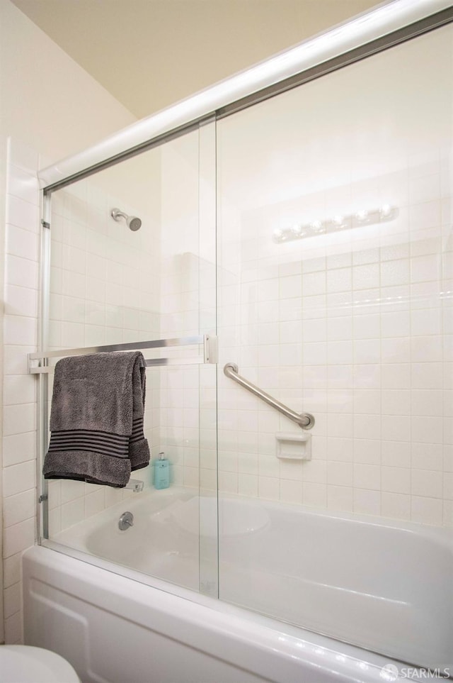 bathroom with shower / bath combination with glass door