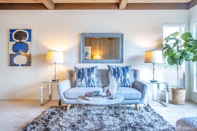 carpeted living room with beamed ceiling