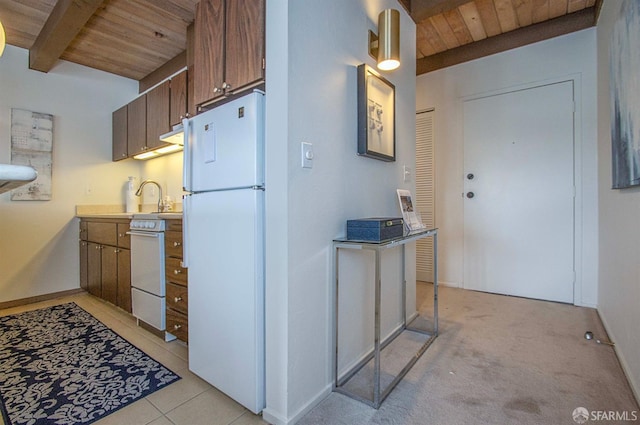 kitchen with wood ceiling, white appliances, light colored carpet, beam ceiling, and sink