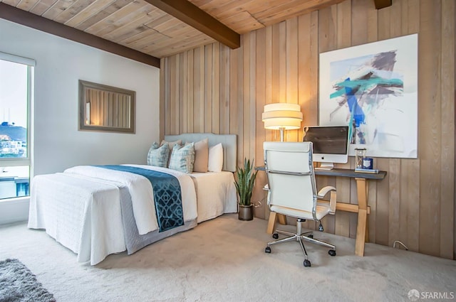 carpeted bedroom with beamed ceiling, wood ceiling, and wooden walls