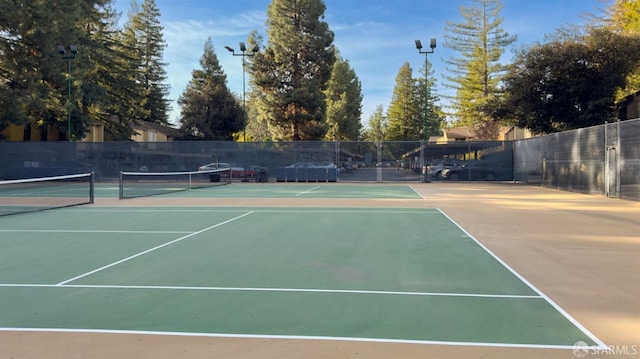 view of sport court featuring fence