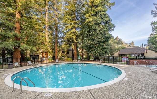 view of pool featuring fence