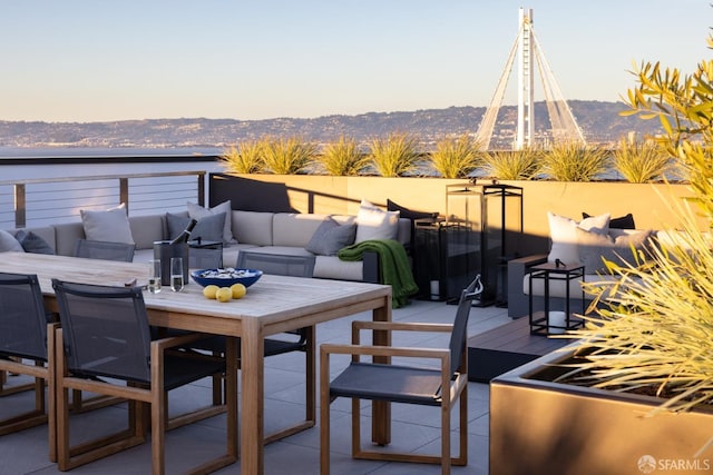 view of patio / terrace featuring a mountain view, an outdoor hangout area, and outdoor dining space