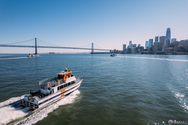 property view of water featuring a city view and a boat dock