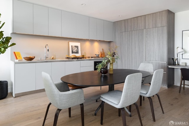 dining space featuring light wood finished floors