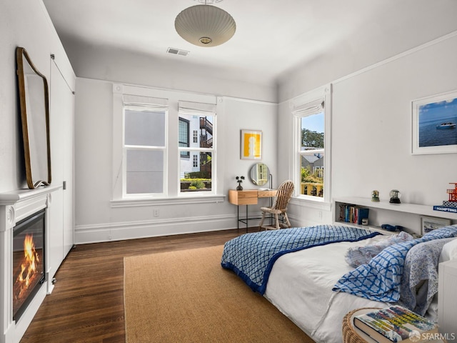 1850 Laguna St, San Francisco, CA 94115 - bedroom with dark wood-style flooring, a glass covered fireplace, and baseboards