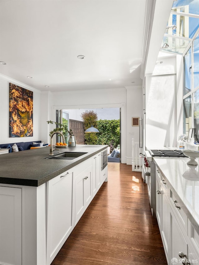 1850 Laguna St, San Francisco, CA 94115 - kitchen with a sink, white cabinets, dark wood finished floors, stove, and dark countertops