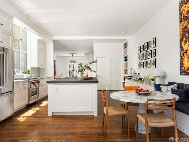 1850 Laguna St, San Francisco, CA 94115 - kitchen with high end appliances, a sink, dark wood finished floors, breakfast area, and white cabinetry