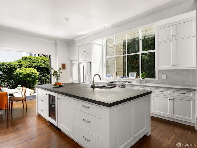 1850 Laguna St, San Francisco, CA 94115 - kitchen featuring a sink, ornamental molding, a kitchen island with sink, white cabinets, and high end refrigerator