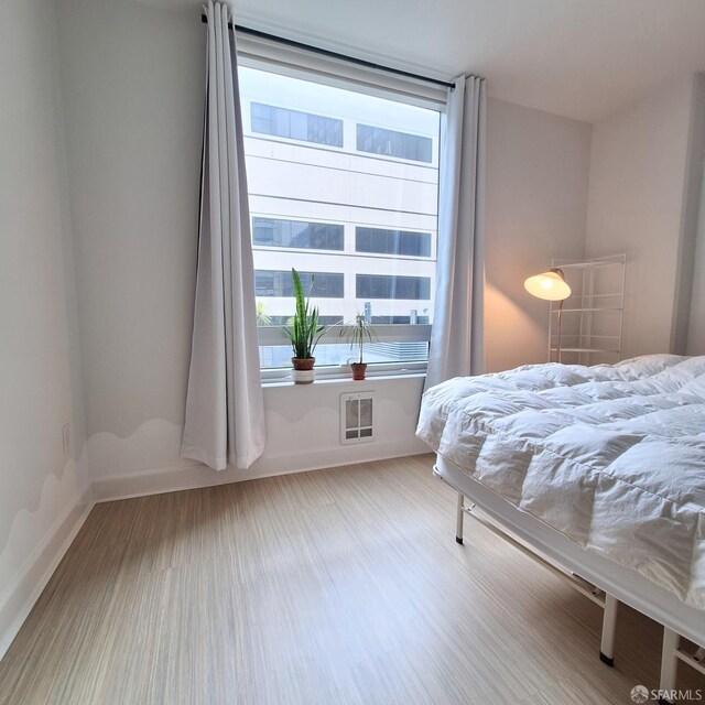 bedroom with wood-type flooring