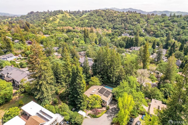 birds eye view of property featuring a view of trees