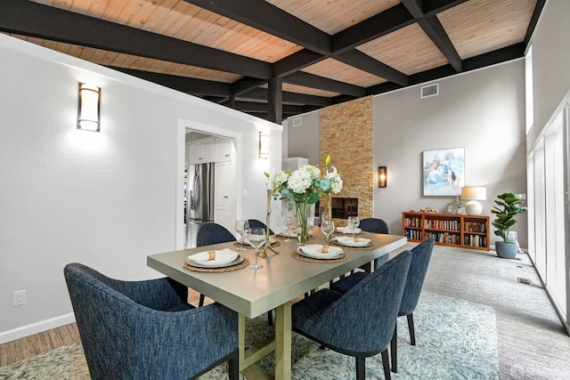 dining area featuring visible vents, wooden ceiling, baseboards, and beam ceiling
