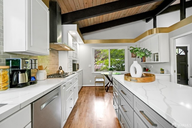 kitchen featuring tasteful backsplash, extractor fan, vaulted ceiling with beams, wooden ceiling, and appliances with stainless steel finishes