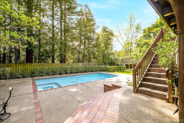 view of swimming pool featuring a fenced in pool, a fenced backyard, an in ground hot tub, stairway, and a patio