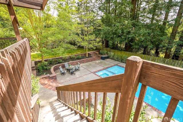 exterior space with a fenced in pool, a fenced backyard, and a patio