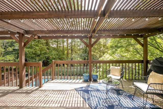 wooden deck featuring a pergola and an outdoor pool