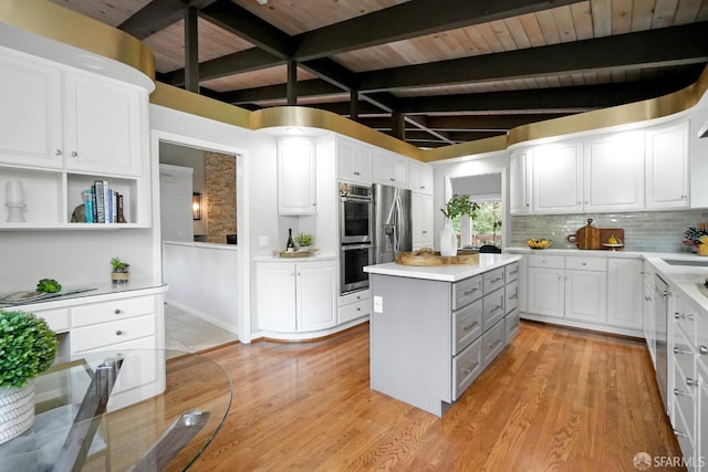 kitchen with light wood finished floors, white cabinetry, and stainless steel appliances