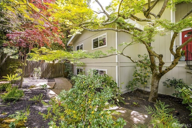 view of home's exterior with fence