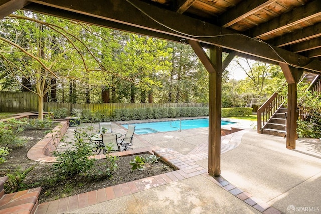 view of swimming pool featuring stairway, a fenced backyard, a fenced in pool, and a patio