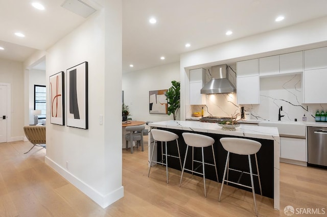 1935-1937 Greenwich St, San Francisco, CA 94123 - kitchen featuring modern cabinets, a kitchen island, wall chimney range hood, white cabinetry, and stainless steel dishwasher