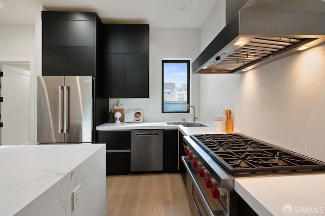 1935-1937 Greenwich St, San Francisco, CA 94123 - kitchen with high end appliances, light countertops, wall chimney range hood, modern cabinets, and dark cabinets