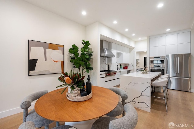 1935-1937 Greenwich St, San Francisco, CA 94123 - kitchen with stainless steel appliances, light countertops, wall chimney exhaust hood, and modern cabinets