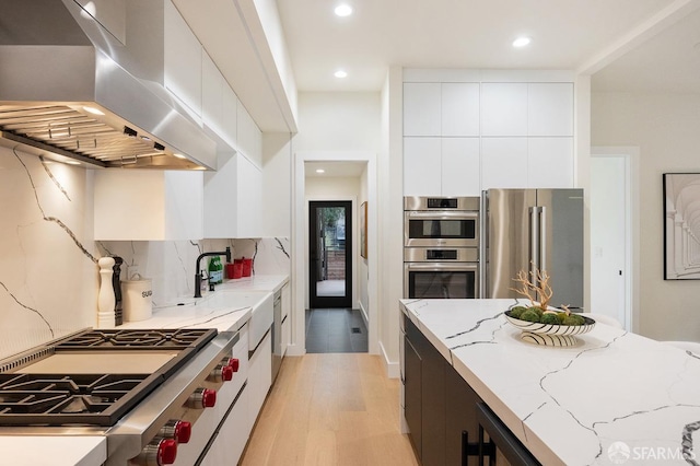 1935-1937 Greenwich St, San Francisco, CA 94123 - kitchen featuring modern cabinets, island range hood, high end appliances, and light stone counters