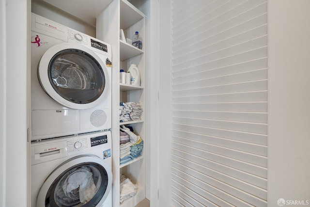 laundry area featuring stacked washer and clothes dryer